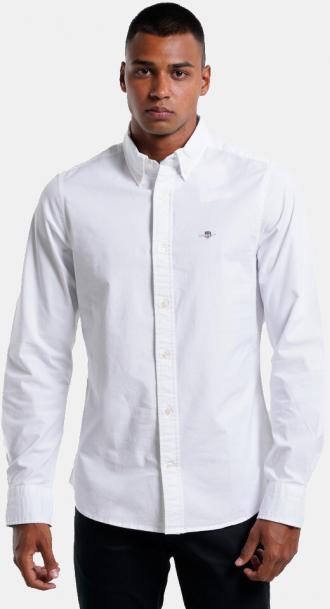 Ένα all time classic πουκάμισο που δεν πρέπει να λείπει από την γκαρνταρόμπα σου. Είναι κατασκευασμένο από απαλό ύφασμα υψηλής ποιότητας για εξαιρετική αίσθηση. Ιδανικό για να σε συνοδεύσει στις lifestyle εμφανίσεις σου. Πληροφορίες • Σύνθεση: 100% βαμβάκι • Κανονική εφαρμογή • Κλείσιμο με κουμπιά • Εμβληματικός γιακάς • Τσέπη στο στήθος • Κουμπιά στις μανσέτες • Απαλή αίσθηση Extra Λεπτομέρειες • Branding Gant • Χρώμα: Άσπρο