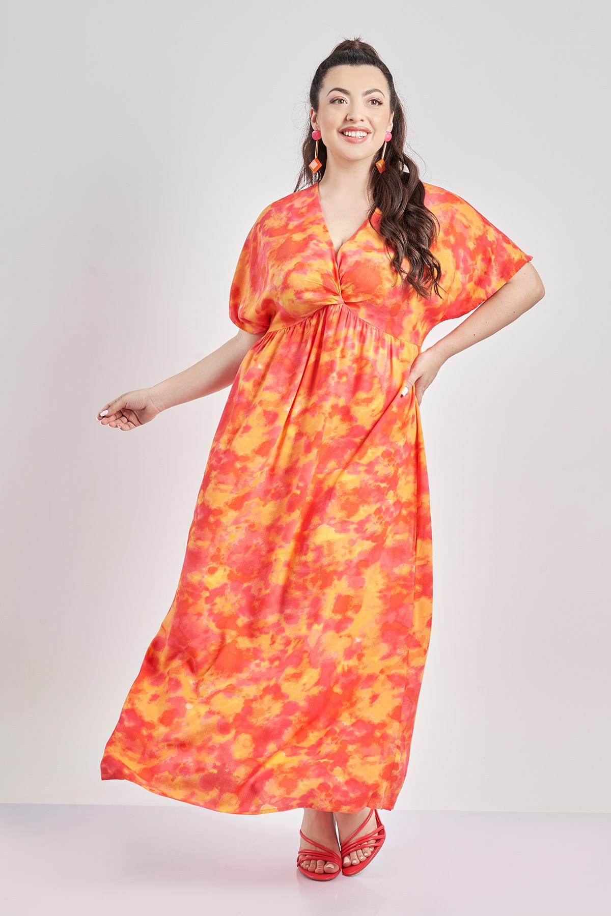 Εμπριμέ μίντι φόρεμα με abstract tie dye. Λαιμόκοψη V και λεπτομέρεια κόμπου μπροστά. Κοντά μανίκια. Αμπίρ γραμμή.Το κύριο υλικό αυτού του προϊόντος είναι ίνες βισκόζης LENZING™ ECOVERO™ με χρήση ξυλοπολτού που προέρχεται από δάση με βιώσιμη διαχείριση και παράγεται με τρόπο που μειώνει τις περιβαλλοντικές επιπτώσεις.