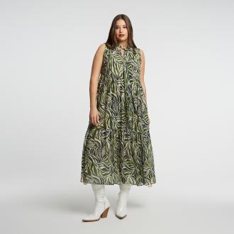 Ένα φόρεμα που ξεχωρίζει με το jungle-inspired print του σε πράσινους και γήινους τόνους. Το αμάνικο σχέδιο και το ελαφρύ ύφασμα προσφέρουν άνεση και στυλ για τις ζεστές μέρες ή τις καλοκαιρινές βραδιές. Το τελείωμα με πτυχώσεις χαρίζει αέρινη κίνηση και μια μοντέρνα πινελιά. ● Φτιαγμένο από ανάλαφρο πολυεστέρα ● Εντυπωσιακό ζεβρέ σχέδιο σε γήινες αποχρώσεις ● Άνετη γραμμή χωρίς μανίκια ● Δέσιμο στον λαιμό για κομψή εμφάνιση Μήκος (κέντρο της πλάτης): 137 εκ 100%POLYESTER Το μοντέλο έχει ύψος 1,80 εκ. και φοράει S/M 